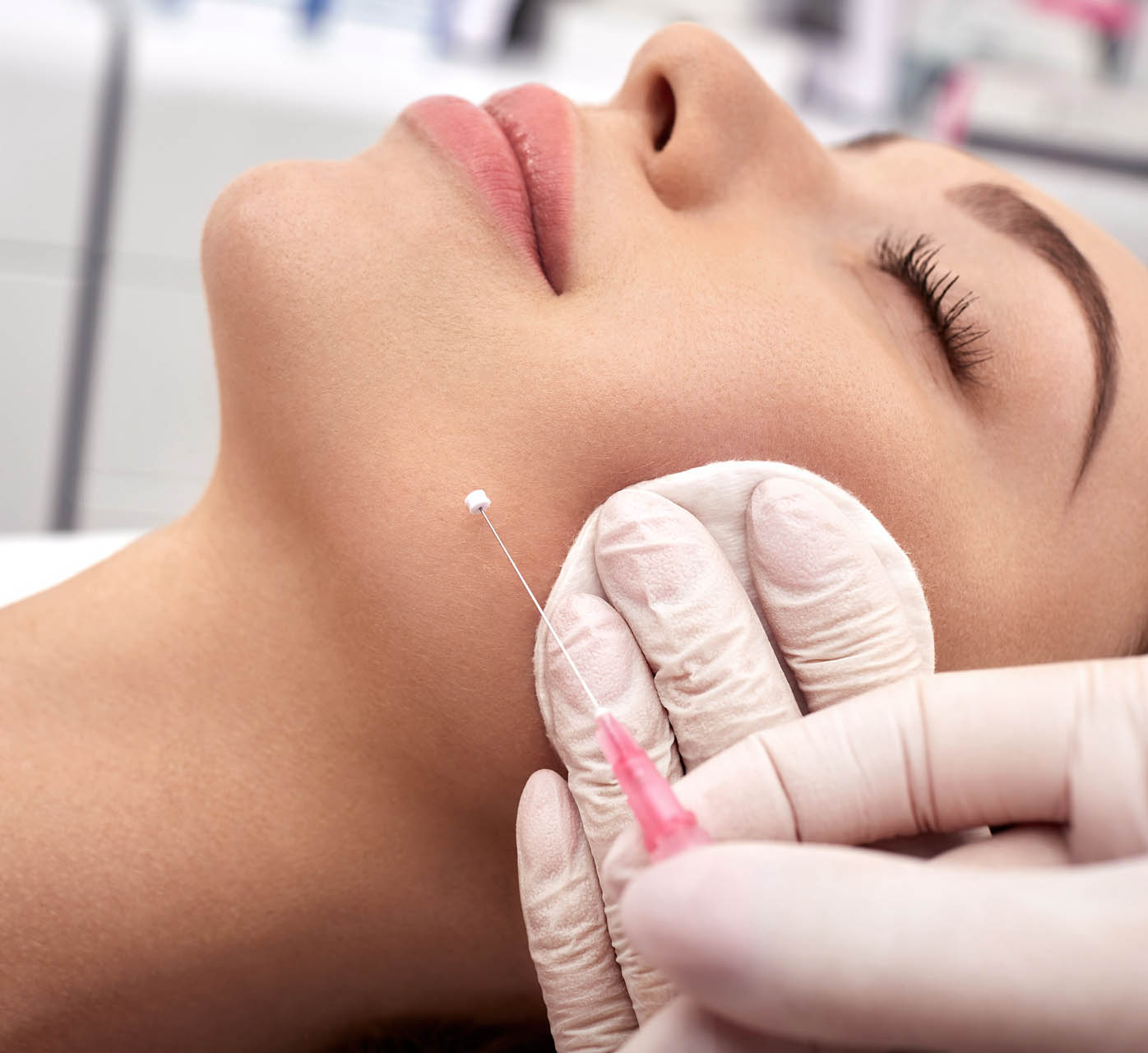 Woman receives a facelift, procedure mesothreads lifting skin. Cosmetic surgery, meso-threads lift, and contouring face